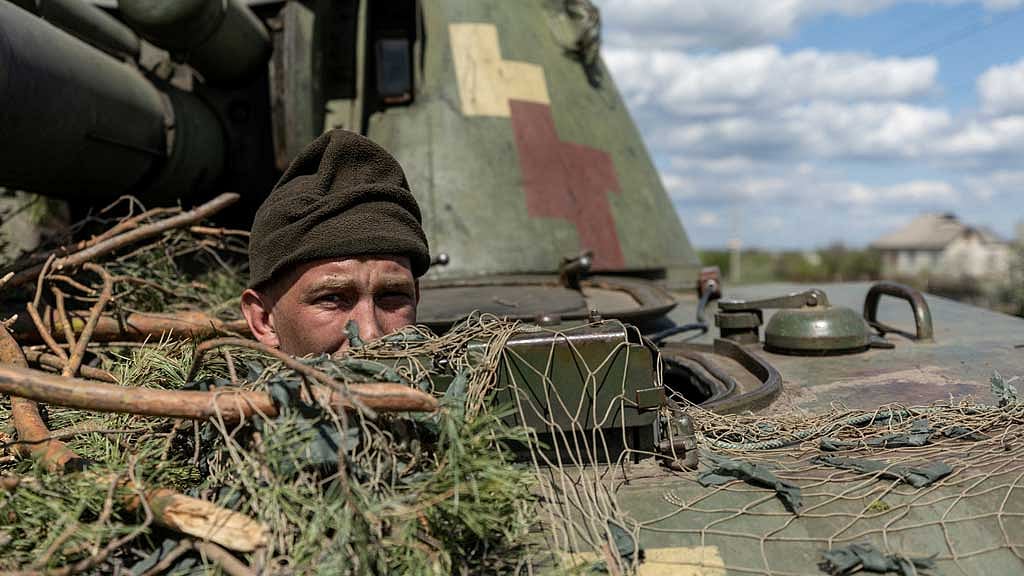 Ukraine troops say they take key town, Putin ally mulls possible nuclear response