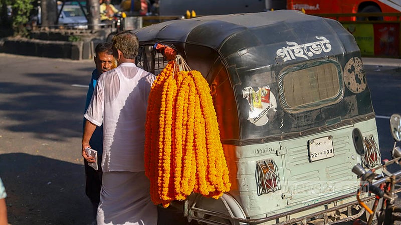 Customers take auto-rickshaws or rickshaws to return to their destinations after purchasing flowers from the morning wholesale flower market in Shahbagh on Friday, Sept 2, 2022.
