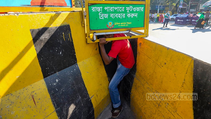 Signposts on road dividers in Dhaka’s Mohakhali keep warning pedestrians about the dangers of jaywalking, but the people have little respect for traffic laws as the photograph taken on Sunday, Oct 23, 2022 shows.