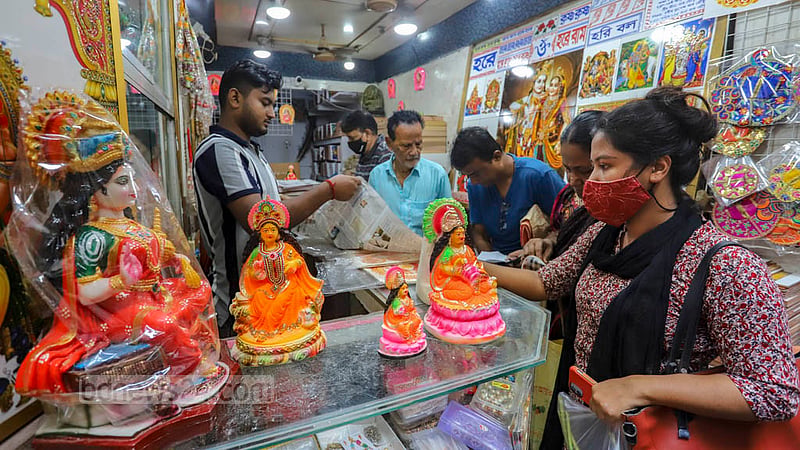 On the occasion of Lakshmi Puja, shoppers look at idols of the Hindu goddess of wealth in Old Dhaka's Shankhari Bazar.