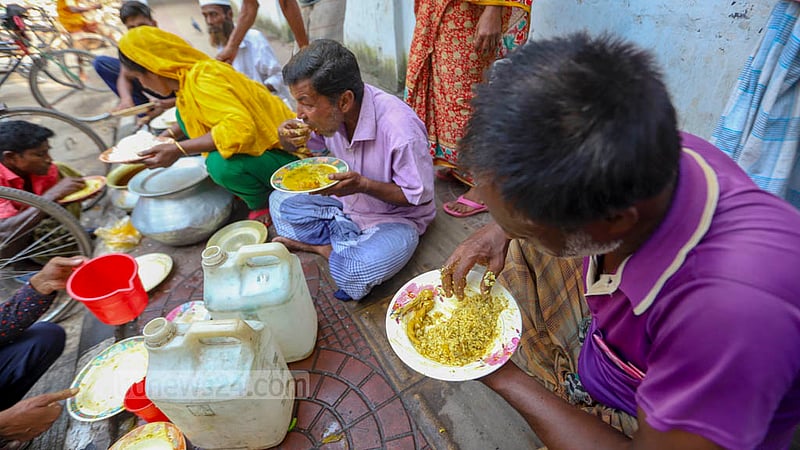 Low-income people eat all they can for a fixed price at shops on the footpaths of Dhaka University.