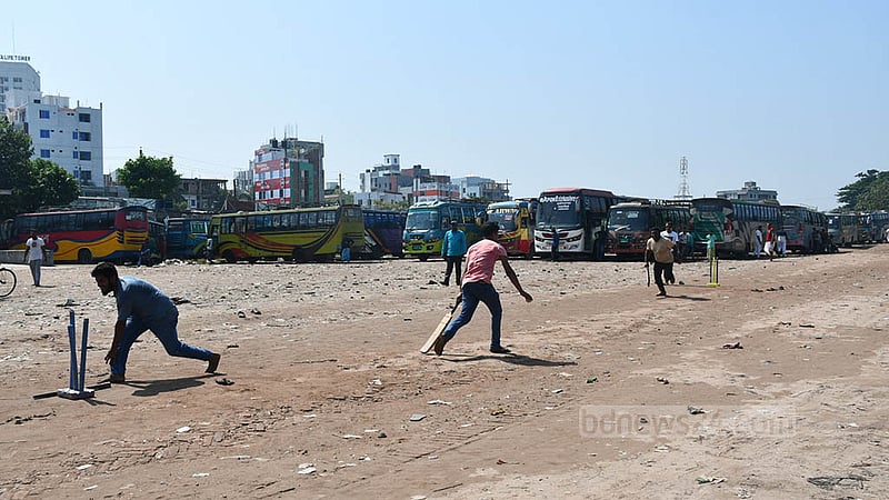 Transport workers play cricket at Khulna bus terminal on Friday, Oct 21, 2022 as the associations of owners and workers halt services for two days ahead of a BNP rally.