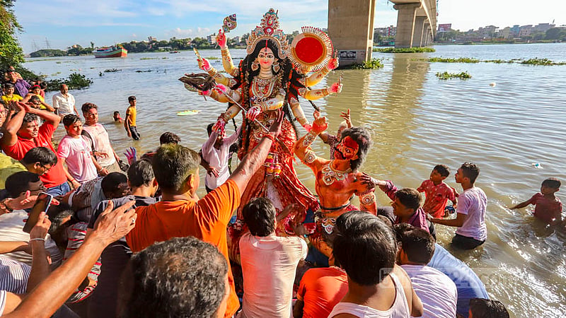 Hindu devotees immerse idols of goddess Durga in the Buriganga river at Basila in Mohammadpur on Bijoya Dashami on Wednesday, Oct 5, 2022.