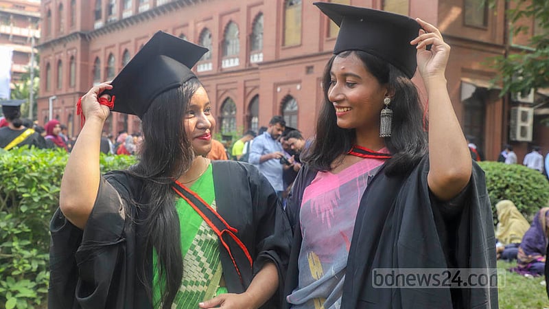 Dhaka University students wearing graduation gowns and caps pose for a photo at Curzon Hall on Friday, Nov 18, 2022, ahead of their 53rd convocation. Photo: Asif Mahmud Ove