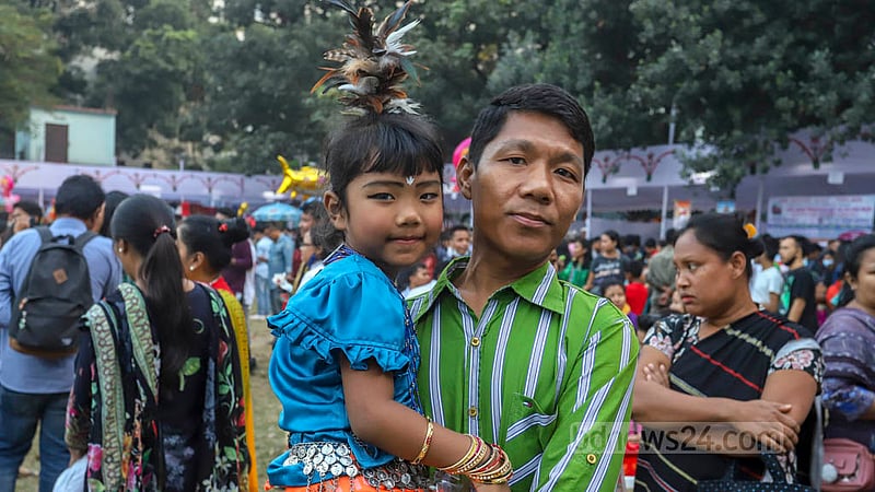 A child wearing traditional Garo attire joins harvest festival Wangala at Banani Bidyaniketan on Friday, Nov 18, 2022. Photo: Asif Mahmud Ove