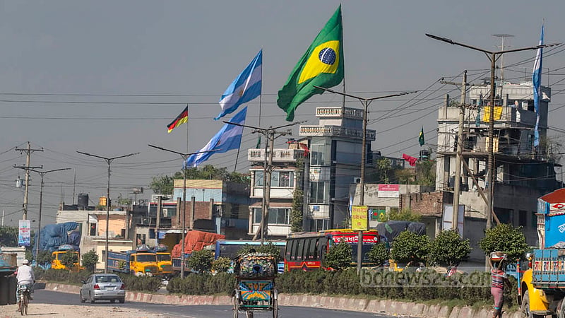 The arrival of the World Cup, famed as the greatest show on earth, is marked by the fluttering flags in Amin Bazar on Sunday, Nov 20, 2022. Photo: Asif Mahmud Ove