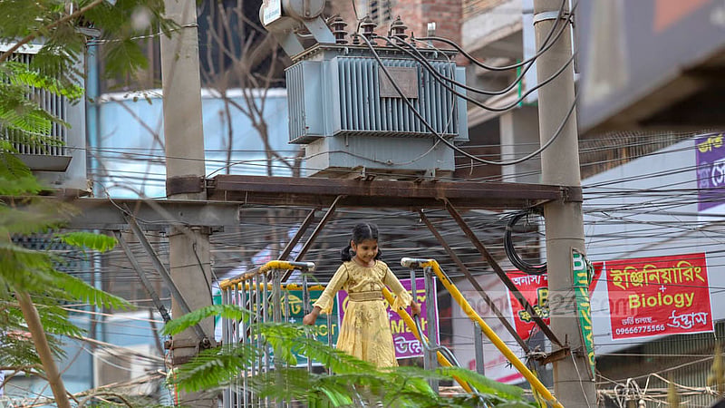 There are two transformers right next to a slider in a small playground for children in Dhaka's Lakshmi Bazar. Photo: Mahmud Zaman Ovi