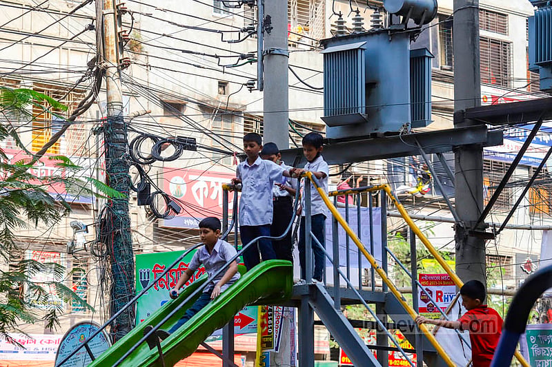From a distance, it seems that children are playing on the slider beneath the transformers above their heads. Transformers are a few yards away from the children but still pose a risk for them if there is an explosion. Photo: Mahmud Zaman Ovi