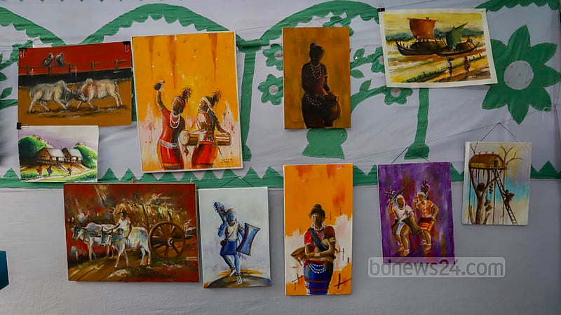 Paintings by Garo artists are on display during harvest festival Wangala at Banani 
Bidyaniketan on Friday, Nov 18, 2022. Photo: Asif Mahmud Ove