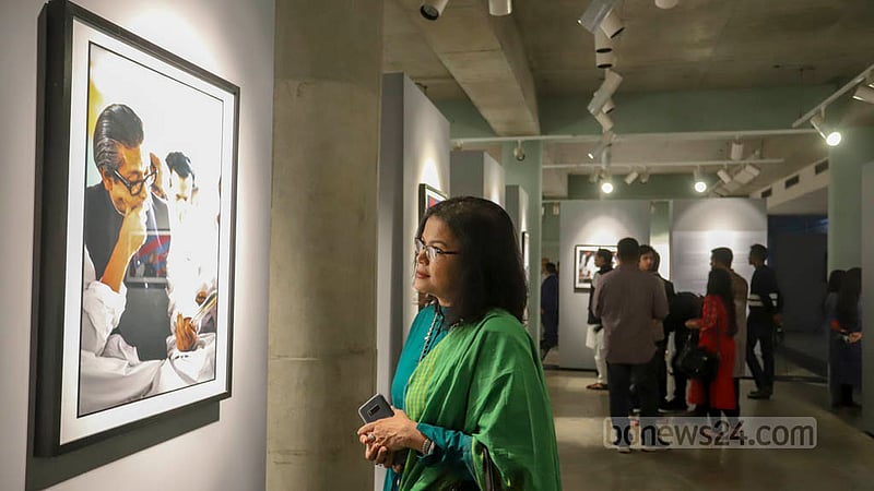A visitor takes a closer look at a photo displayed at the “Witnessing History in the Making: Photographs by Anne de Hemming” exhibition at the Liberation War Museum on Thursday, Dec 15, 2022.
