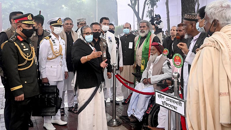 Prime Minister Sheikh Hasina exchanges greetings with freedom fighters after paying tribute to the slain intellectuals of 1971 at the Martyred Intellectuals’ Memorial in Dhaka’s Mirpur on Wednesday, Dec 14, 2022. Photo: PMO