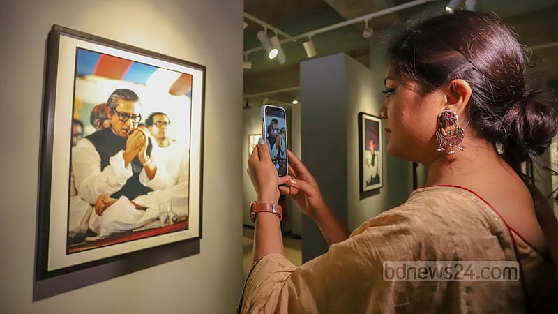 A visitor takes a closer look at a photo displayed at the “Witnessing History in the Making: Photographs by Anne de Hemming” exhibition at the Liberation War Museum on Thursday, Dec 15, 2022.