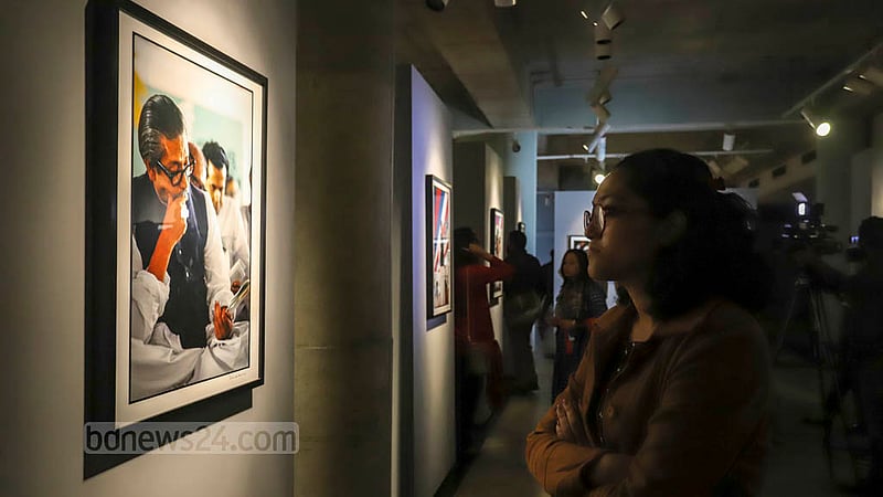 A visitor takes a closer look at a photo displayed at the “Witnessing History in the Making: Photographs by Anne de Hemming” exhibition at the Liberation War Museum on Thursday, Dec 15, 2022.