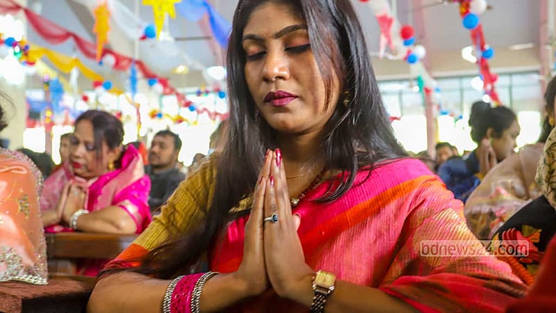 A woman prays on Christmas Day at the Holy Rosary Church in Dhaka’s Tejgaon on Dec 25, 2022. Photo: Asif Mahmud Ove