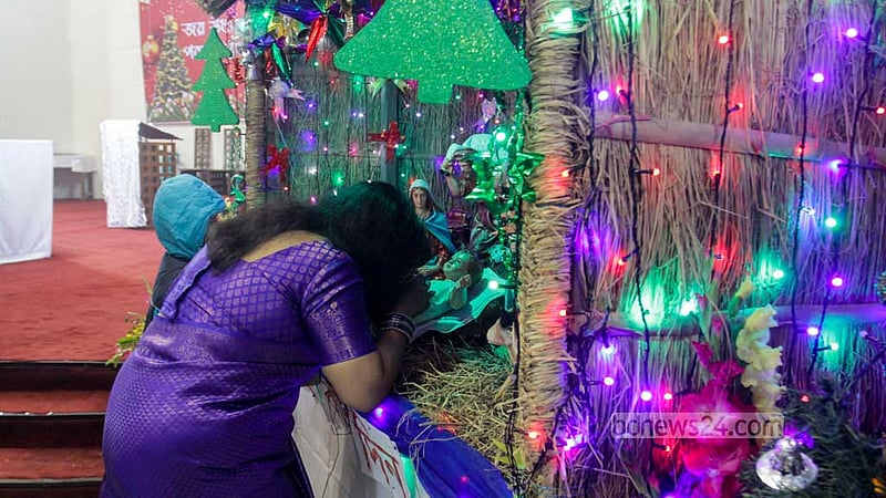A woman prays on Christmas Day at the Holy Rosary Church in Dhaka’s Tejgaon on Dec 25, 2022. Photo: Asif Mahmud Ove