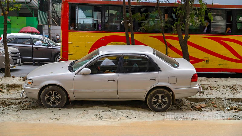 Drivers are damaging parts of the road divider while parking cars on the section of the road that was dug up to install sewage pipes.