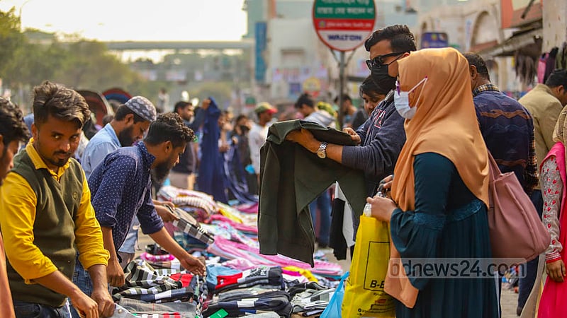Customers are crowding makeshift shops to buy winter clothes as the cold intensifies in Dhaka.
