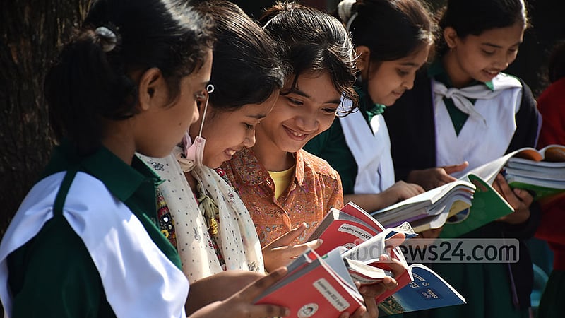 Students of Dr Khastagir Government Girls High School in Chattogram take a look at the new textbooks they received on Sunday, Jan 1, 2023. Photo: Suman Babu