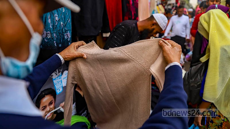 The number of customers at the makeshift shops of winter clothes on the footpaths outside New Market in Dhaka is higher than usual as the cold intensifies.