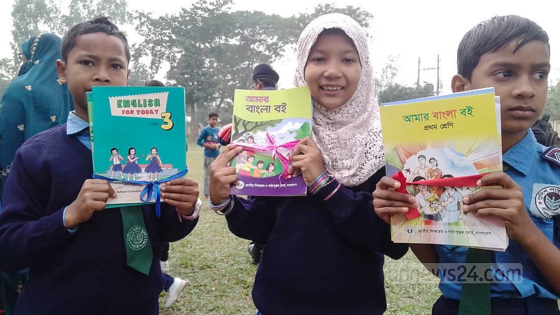 Students of Gaibandha’s Police Lines School react after getting new textbooks on New Year’s Day, on Sunday, Jan 1, 2023. Photo: Asfikur Rahman Asif