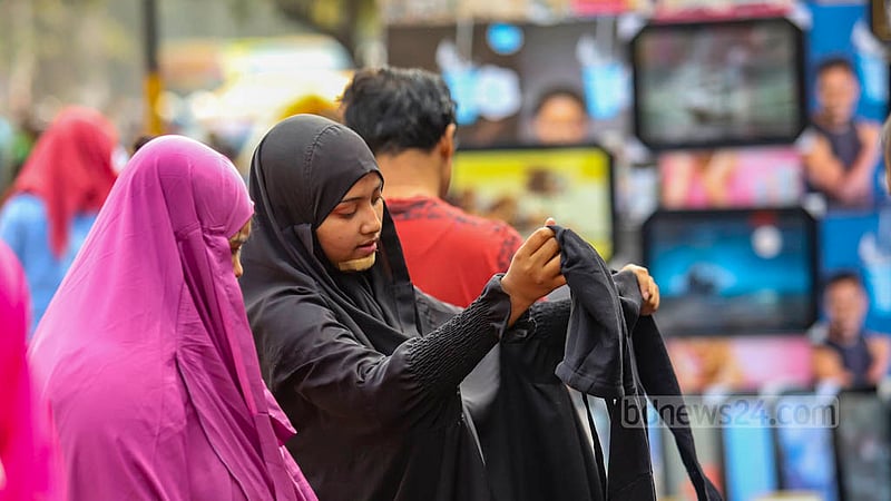 Customers crowd makeshift shops of warm clothes on the footpath outside New Market in Dhaka.