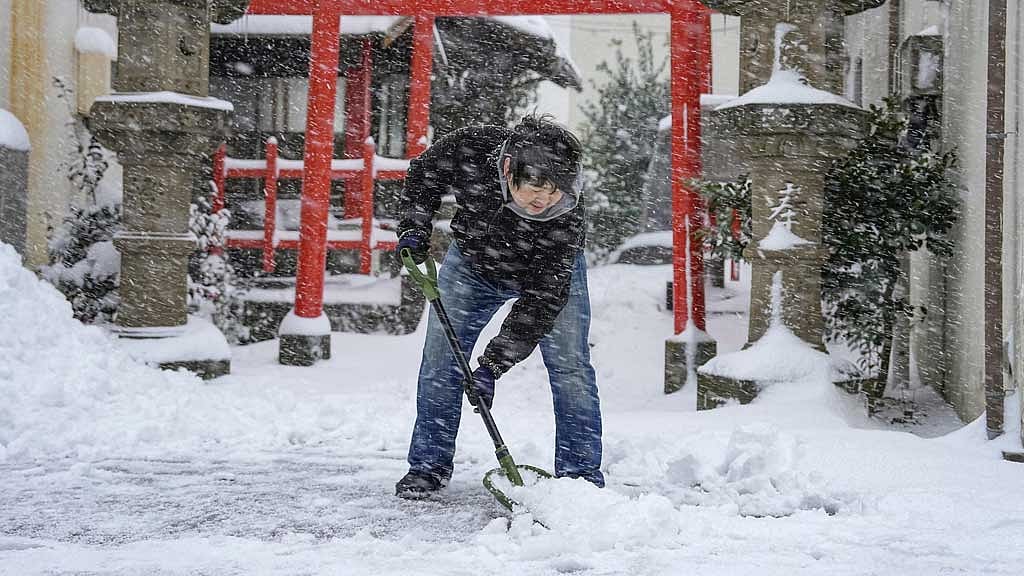 Heavy snow in Japan disrupts flights and trains, closes roads