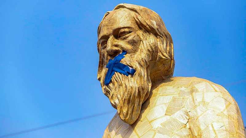 With the help of their peers in the Faculty of Fine Arts, a group of Dhaka University students have installed a statue of Rabindranath Tagore on the campus with the mouth taped and a book in its hands nailed.
