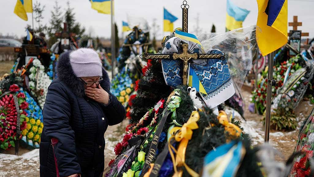 One year into invasion, Ukraine mourns dead and vows victory