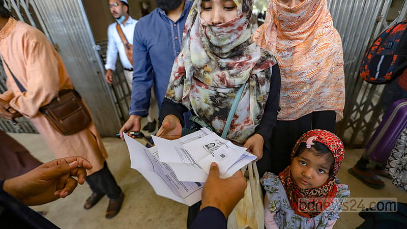 Passenger's name on the ticket is verified against their national ID card at Kamalapur Railway Station in Dhaka on the first day of a new train ticket sale system on Wednesday, Mar 1, 2023. Photo: Mahmud Zaman Ovi