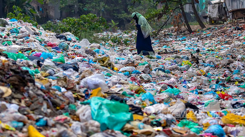 People walk on the surface of the Shubhaddya canal, which has been totally covered with garbage. Photo: Mahmud Zaman Ovi