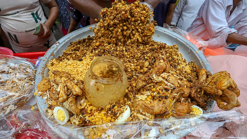 The Iftar item called “Boro Baper Polai Khai” is a mixture of ground beef, cow liver, cow brain, chicken, flattened rice, lentils, kebabs, potato, egg and 12 types of spices; people from across the capital visit Chawkbazar to break Ramadan fast with traditional food. Photo: Asif Mahmud Ove