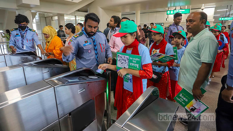 Children entering Agargaon Metro Rail Station for a joy ride on Bangabandhu's birth anniversary and National Children's Day on Friday, Mar 17, 2023. Photo: Asif Mahmud Ove