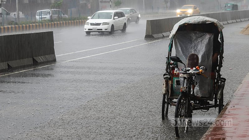 A rickshaw driver wraps himself in plastic to stave off the rain on Sunday, May 19, 2023. Photo: Asif Mahmud Ove