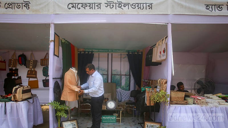 Owners decorate their stalls and arrange goods at the Jute Product Fair organised by the textiles and jute ministry in the Shilpakala Academy. Photo: Tawhiduzzaman Tapu