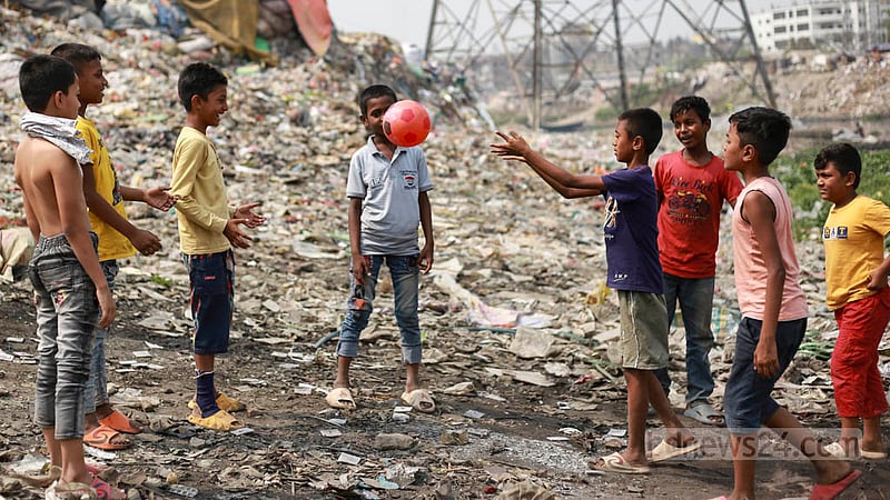 Children are using Koyla Ghat waste disposal space in Kamrangirchar as a playground to play football on Thursday, Mar 16, 2023. Photo: Tawhiduzzaman Tapu