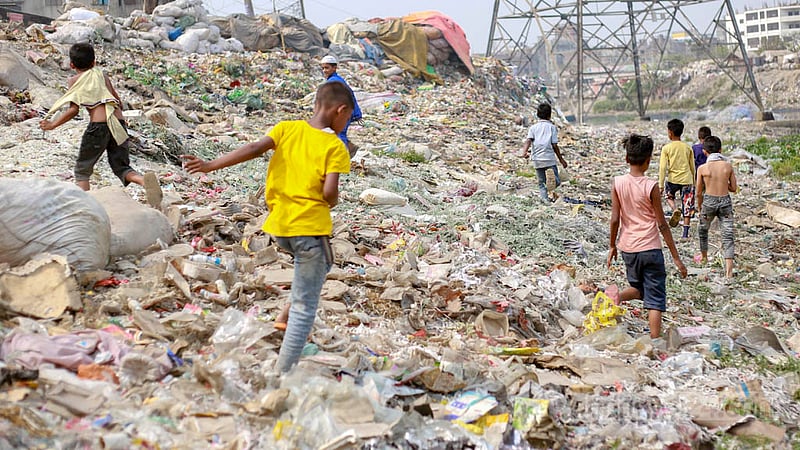 The waters of some streams of the Buriganga dry up during the winter revealing huge areas of plastic, polythene and other wastes. Some children are using the dirty place as a playground on Thursday, Mar 16, 2023. Photo: Tawhiduzzaman Tapu
