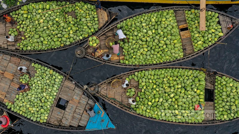Watermelon stacked up on boats will be stored in the depot at Old Dhaka’s Wais Ghat. Photo: Mostafigur Rahman