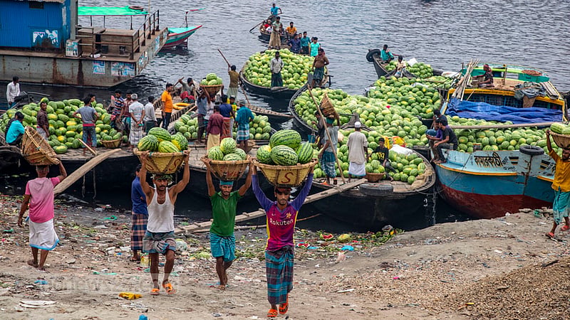 Workers carry watermelons to the depot at Old Dhaka’s Wiseghat. Photo: Mostafigur Rahman