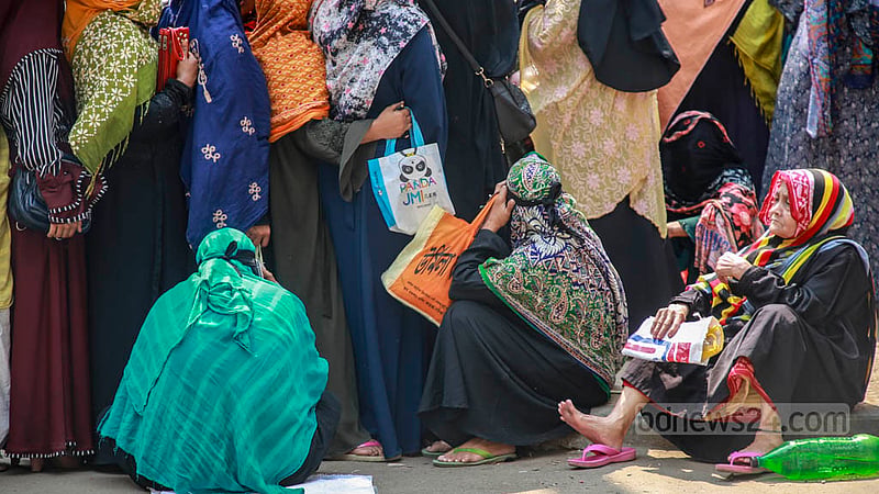 Women, children and the elderly suffered due to a long wait for Ramadan goods at subsidised prices outside the shop of a Trading Corporation of Bangladesh dealer at Azimpur in Dhaka on Thursday, Mar 23, 2023. Photo: Tawhiduzzaman Tapu
