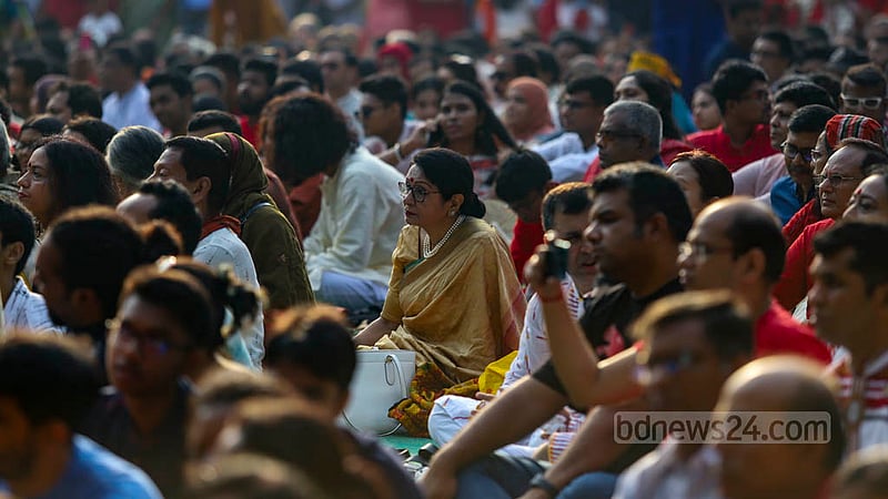 A woman enjoys a performance presented by artistes from Chhayanaut at Ramna Batamul in Dhaka on Pahela Boishakh, the first day of the Bengali New Year 1430. Photo: Mahmud Zaman Ovi