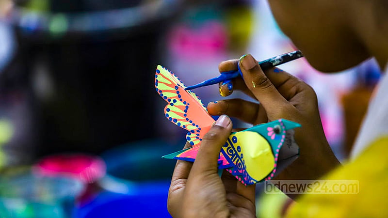 Dhaka University’s fine arts students are crafting paper birds to be sold at their stalls at the entrance of their faculty premises during the Bangla New Year festival. Photo: Mahmud Zaman Ovi