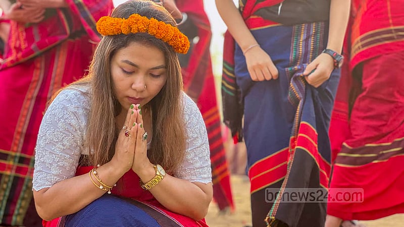 Chakma youths float flowers in Chengi and Maini rivers at dawn, praying for the best in the new year to their goddess Ganga. Photo: Samir Mallik