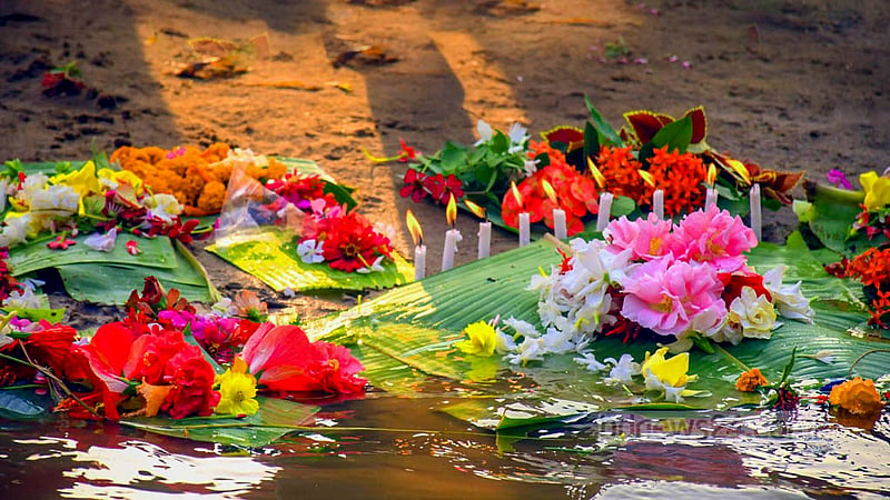 Chakma youths float flowers in Chengi and Maini rivers in Khagrachhari to welcome the Bangla new year.Photo: Samir Mallik