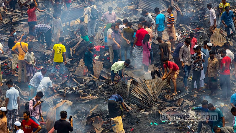 As soon as the fire at Bangabazar was extinguished, people began digging through the debris for iron and tin. Photo: Mahmud Zaman Ovi