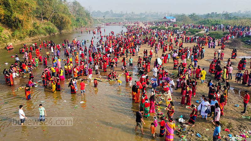 Chakma people celebrate Biju by floating flowers in the river at the break of dawn on the first day of the Vaisabi festival. Photo: Samir Mallik