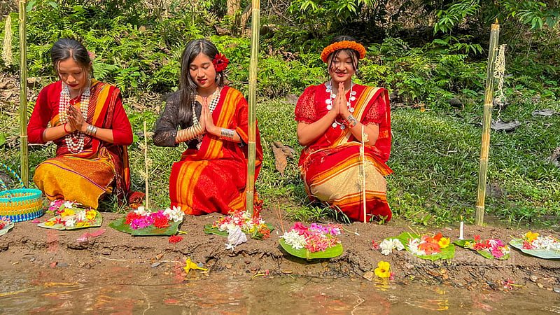 Tripura women offer prayers near a hillside waterfall during the Vaisu festival in Khagrachhari's Khagrapur area.