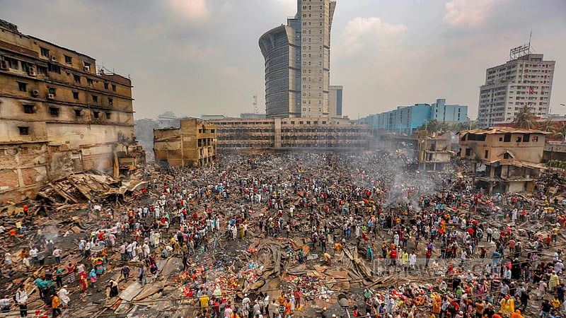 Apr 5: People collect half-burnt clothes, tin sheets and pieces of metal after a devastating blaze at Bangabazar. 