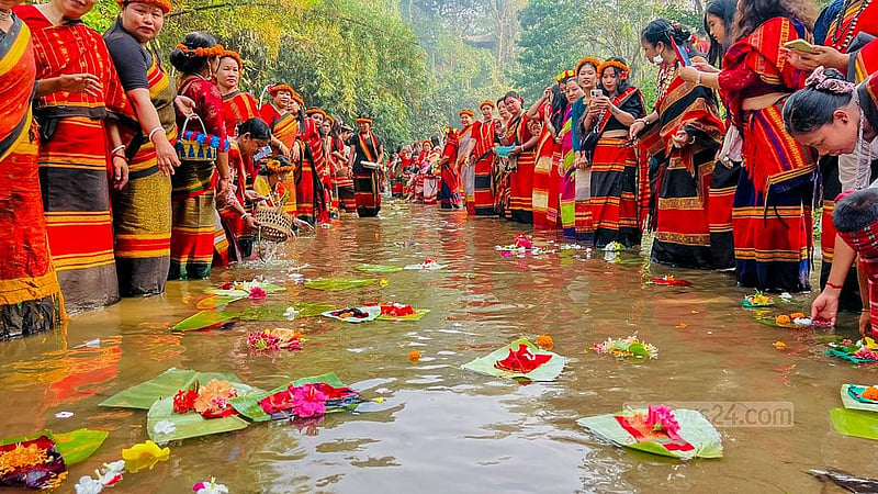 Tripura women offer new hand-woven cloth to Goddess Ganga near a hillside waterfall in Khagrachhari's Khagrapur area, praying for improved weaving skills.