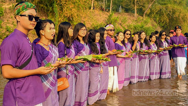 Chakma youths float flowers in Chengi and Maini rivers in Khagrachhari to welcome the Bangla new year. Photo: Samir Mallik