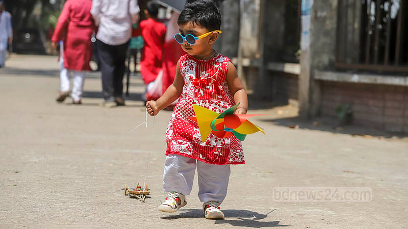 Children adorned in Baishakhi clothes participate in Dhaka University’s Bangla New Year celebrations on Friday, Apr 14, 2023. Photo: Asif Mahmud Ove